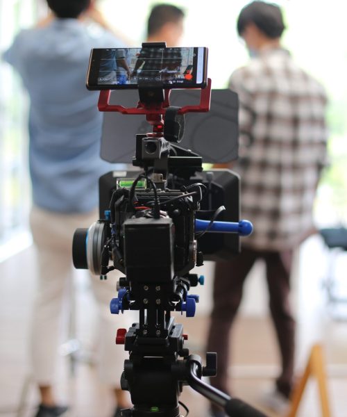Selected focus on camcorder film broadcast against blurred background.